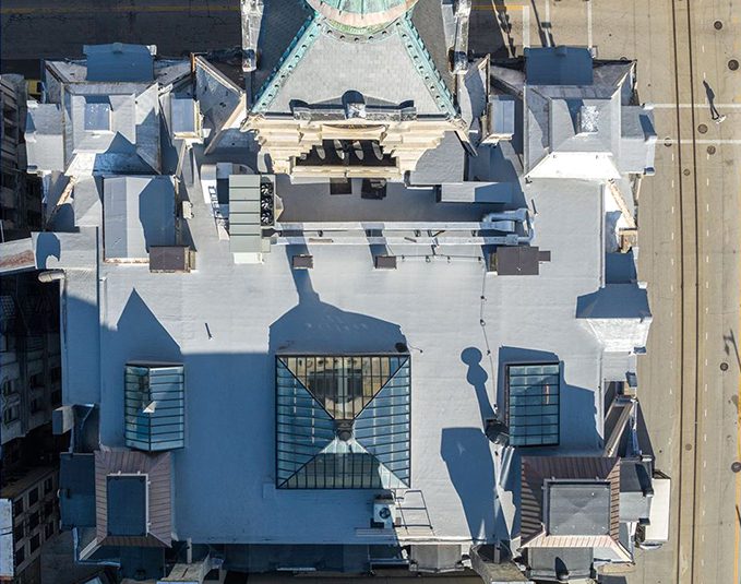 After photo - aerial view of commercial building with completed white roof coating