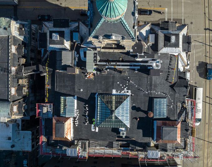 Before photo - aerial view of aged commercial building roof needing restoration
